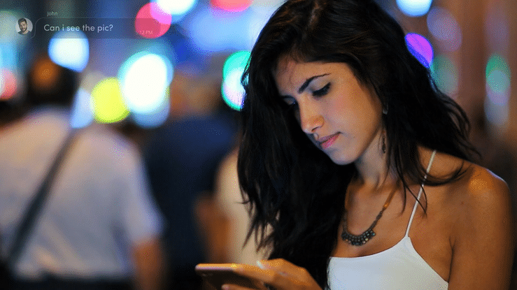 A woman having a text message conversation with another person.