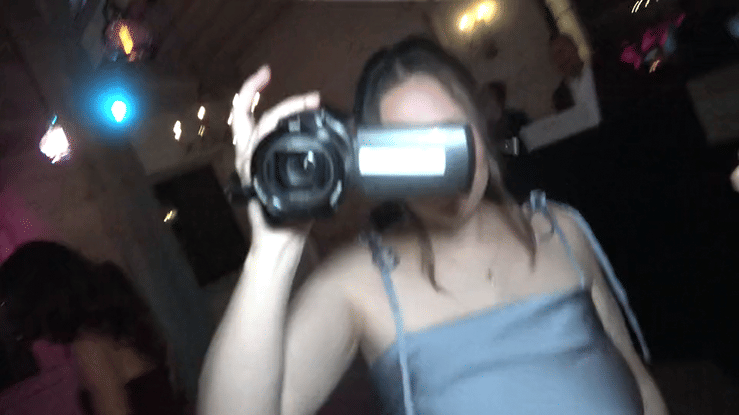 Wedding guests filming the celebration with a Pass the Cam camcorder, looping highlight clip