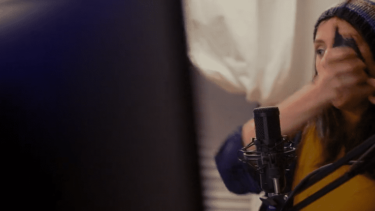 a gif of a video game streamer girl transitioning to a picture in picture effect of her playing a first person shooting game